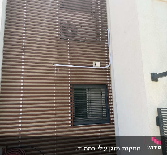 קיר חיצוני עם מזגן וצינור חיצוני